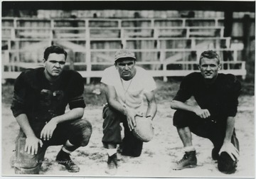 Jack Dillon, left, and Al Morgan,right, pose with their coach in front of the bleachers. 