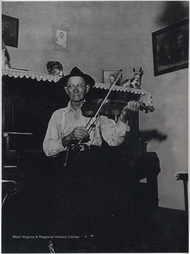 Hartford pictured playing his instrument at the 1717 Temple St. residence. Hartford made fiddles and clocks, and was known for his mastery in woodcraft. 