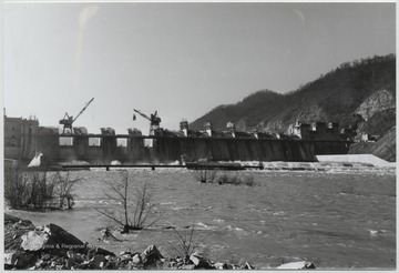 Cranes lift equipment as the construction is under way over the Bluestone River. 