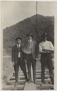 Man in the center is Luther Greene. His associates are unidentified. 