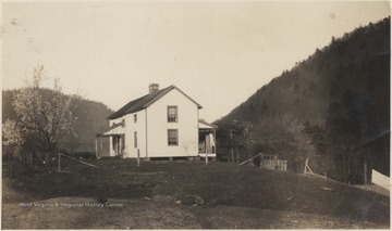 A large white house is pictured in the center. 