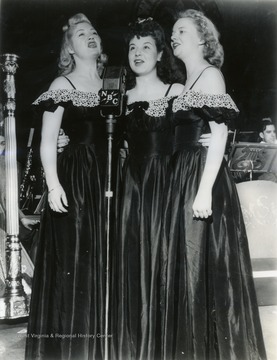 Caption on back of photograph reads: "When the Musical Steelmakers are heard each Sunday, starting October 5, over at Station ___ at ___ o'clock these three pretty singers, the Steel Sisters, will help add to the gaiety and tunefulness of the programs. They are, from the left, Lois Mae Nolte, Harriet Drake, and Lucille Bell. Like other members Musical Steelmakers troupe they are either employees in the steel industry or members of employee families." The first all employee broadcast. The Steel Sisters eventually gained so much recognition that they went on tour with Horace Heidt and his orchestra.