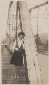 Tommy Smith Trail poses on the bridge's pedestrian walkway.