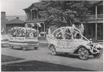 Parade floats make their way down Temple Street.