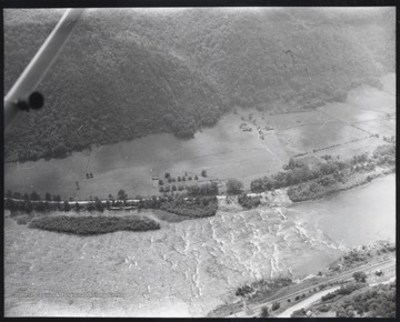 View from an airplane of the river as it is situation below the city.