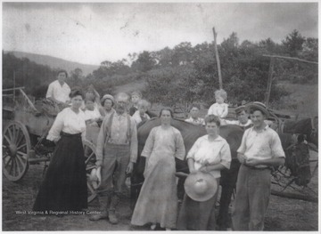 Front row, from left to right, is Kendal Noel (first wife of Henry Senior); Henry Noel Senior; unidentified; Anna Noel (Married to Emmit Henry's second son); and unidentified. Thr group is gathered around a horse-drawn wagon.