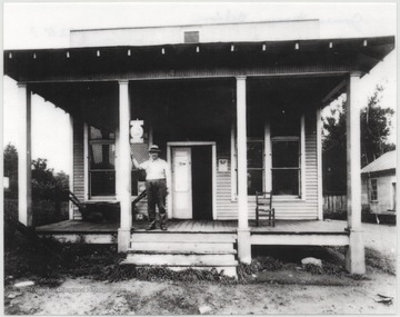 Nelson stands in front of the store entrance, where for 35 years he dealt hardware and feed. Nelson died July 6, 1938 at the age of 68 after years of battling a heart ailment.