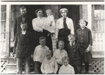 Turner, his wife and children are pictured in front of their home.