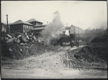 A horse-drawn carriage emerges from the dust carting supplies in and out of the site. 