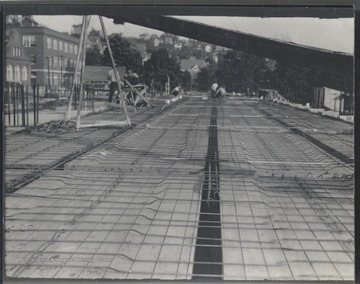 The men are working to construct the ground floor of what is to become the Hall of Chemistry. 