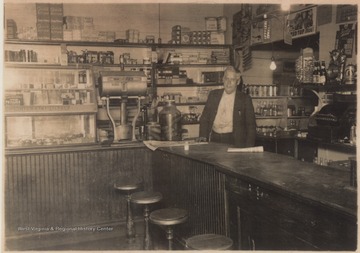 Parker stands behind the store counter.