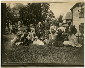 This image is part of the Thompson Family of Canaan Valley Collection. The Thompson family played a large role in the timber industry of Tucker County during the 1800s, and later prospered in the region as farmers, business owners, and prominent members of the Canaan Valley community.A caption on the back of the image reads: "Our yard at Davis, June or July [of 1907].Mr. and Mrs. J.F. Thompson and two daughters, A. Thompson, Mrs. S.W. Thompson, Geo B Thompson and Wife, Maude Wakefield, Leigh Wilson, Ben, Hilda, Albert, and Ruth, Wade Wilson, left of Mrs. J.F. Thompson."