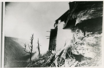 This image is part of the Thompson Family of Canaan Valley Collection. The Thompson family played a large role in the timber industry of Tucker County during the 1800s, and later prospered in the region as farmers, business owners, and prominent members of the Canaan Valley community.The Babcock Lumber and Boom Company bought the Blackwater Lumber and Boom Company from the Thompson family in 1907. It shut down in 1924.  The image shows a train falling from the edge of a mountain.