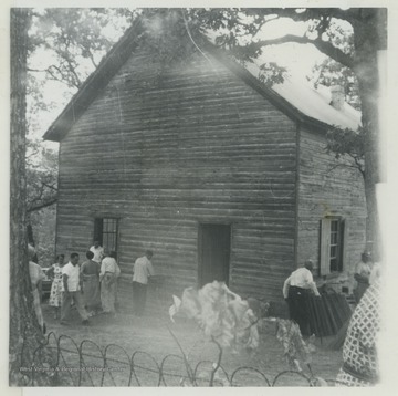 A group of church goers are gathered outside of the church, which was established in the Rock Gap District in 1797. The chapel had a greater influence on rural religion and in the spread of the German Evangelical movement than any other in Morgan County, W. Va. For years, the German preachers of the United Brethren shared the chapel with English Methodist preachers, often conducting services in both the English and German languages. 