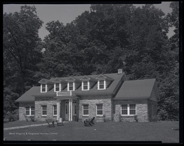 A view of a cottage from across the lawn. 