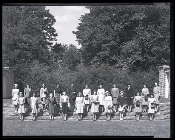 A group of unidentified girls dressed in wool pose for a picture together. 