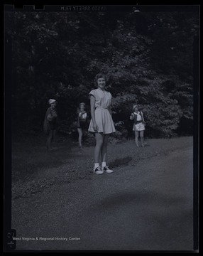 Three girls dressed as 'Three Princes of Serendip' encroach on an "unsuspecting" bystander. Subjects unidentified. 