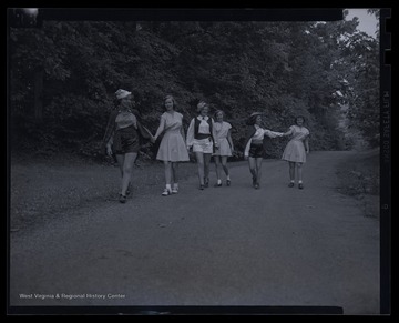 Six unidentified girls walk together in costume as they prepare to perform 'Three Princes of Serendip' play. 