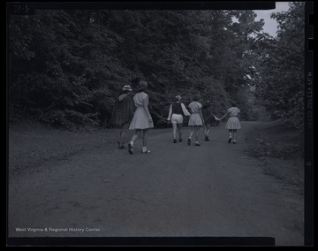 Six unidentified girls walk together in costume as they prepare to perform 'Three Princes of Serendip' play. 