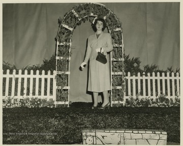 An unidentified woman poses on stage. 