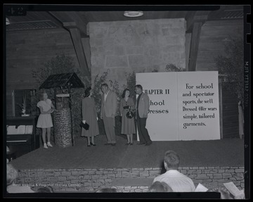 A group presents the appropriate attire for 4-H campers during school and spectator sports. Subjects unidentified. 