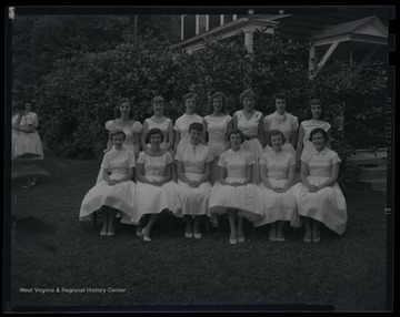 A group of unidentified girls pose together for a group photo. 