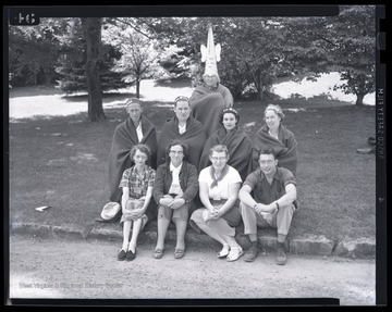 A group of Europeans pose in Native American headdresses during the leadership conference at the State 4-H Camp. 