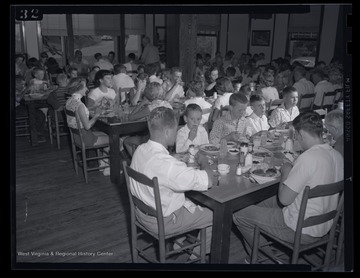 Participants and spectators at the dairy show eat together. 