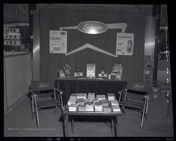 Samples and pamphlets are strewn across tables for the show's attendees. 