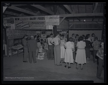 A crowd gathers around the exhibit.