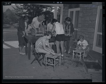 4-H campers prepare stools during their class activities. Subjects unidentified. 