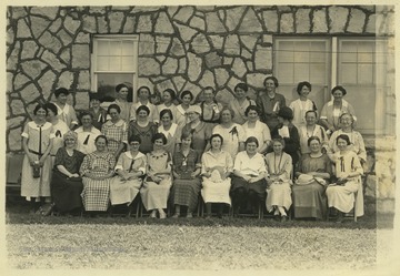 A group of unidentified women pose together for a photo. 