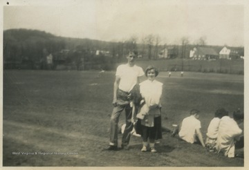 Cooper, left, stands beside a girl that is likely Donna Mae Deberry. 