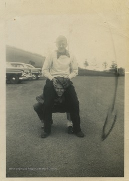 Feathers, top, and Hanger, bottom, goof around in the high school parking lot. 