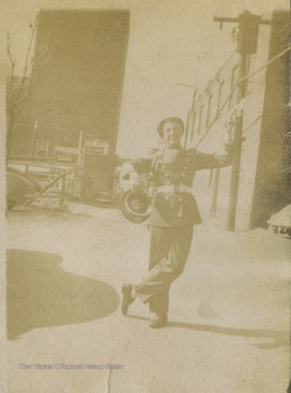 An unidentified student dressed in the marching band uniform poses outside of the high school building. 