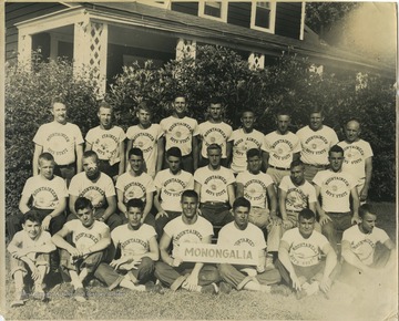 Boys in the Mountaineer Boys' State program gather for a group photo, with members in the front holding a "Monongalia" sign. Subjects unidentified. 