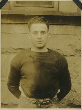 A West Virginia University player identified as "Harris" poses in his football gear.