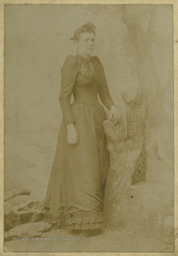 Beaver is pictured standing beside a faux log. 