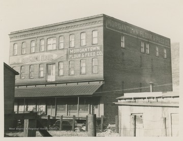 Front of the Morgantown Flour and Feed Co. building on Clay Street.  Large mural for Gold Medal Flour is also on the front of the building.  Photographs taken for the West Virginia Geological Survey.