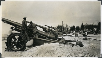 American military work with coastal artillery during a defense campaign. Photograph comes from a U.S.S. West Virginia scrapbook. 