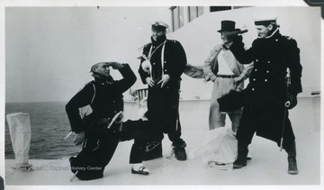 Crew members pal around during the crossing initiation ceremony, where sailors who have never crossed the equator before are "brought before Neptune" and tested. 