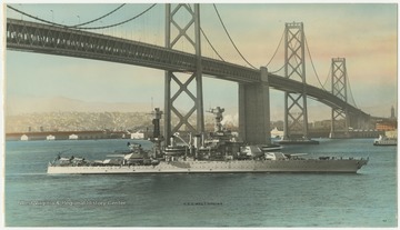 The U.S.S. West Virginia floats beneath the bridge. 