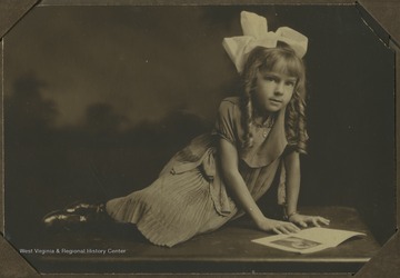 Portrait of a young Wilda Juanita Turner as she reads a book. 