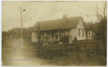 Standing in the front right are Mr. and Mrs. John W. Zinn, parents of Earl Ray Zinn. John Wesley Zinn married Mary M. Corrothers, daughter of William Corrothers who built the house around 1875. Earl R. Zinn married Lillian Arnett Steele.