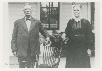 Portrait of Eli H. Westbrook, born ca. 1850, and Uretta (Koon) Westbrook, born ca. 1860.  Eli's hat rests on the wooden chair at the center of the image.