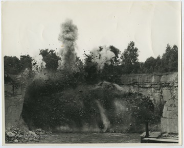 Rocks fly from the thick smoke into the sky.