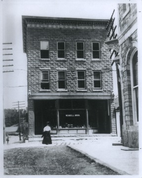 A woman walks by the building entrance, located at the intersection of Court Street and Maple Avenue in Fayetteville.