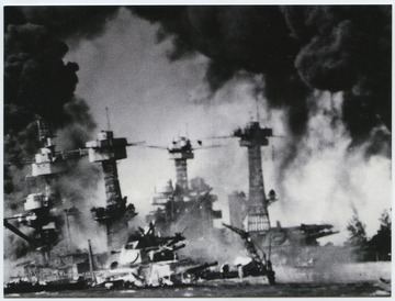 The Japanese hit the "Wee Vee" with nine bombs and torpedoes during the attack. The U.S.S. Tennessee is moored on the right. 