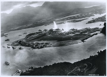 The photograph was taken at the beginning of the attack. The explosion seen in the center of the photograph is a torpedo that struck the U.S.S. West Virginia. 