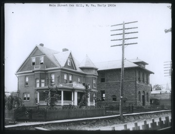 The building on the right is a branch of the Merchants and Miners Bank.